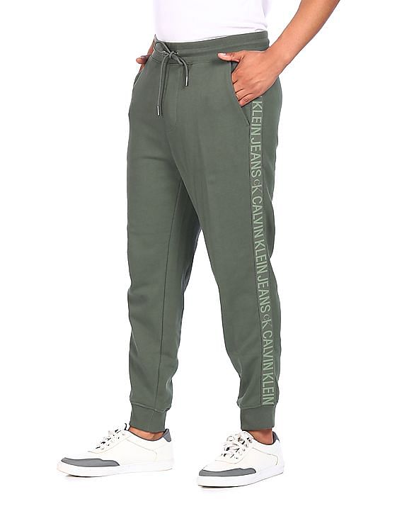 Buy Calvin Klein Men Green Mid Rise Drawstring Waist Brand Tape Track Pants NNNOW